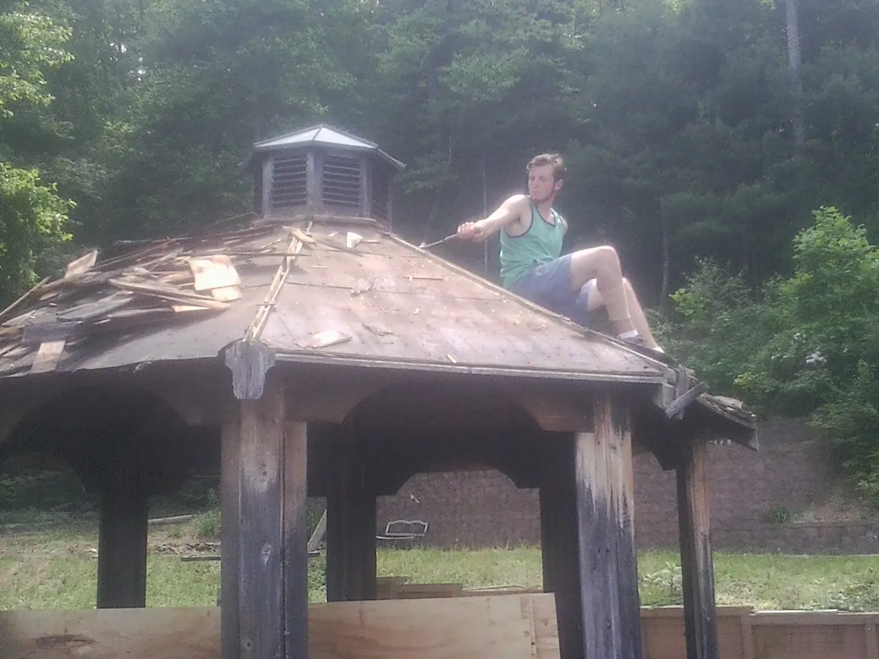 Tearing the old roof off a wooden gazebo before new shakes in Clifton Springs