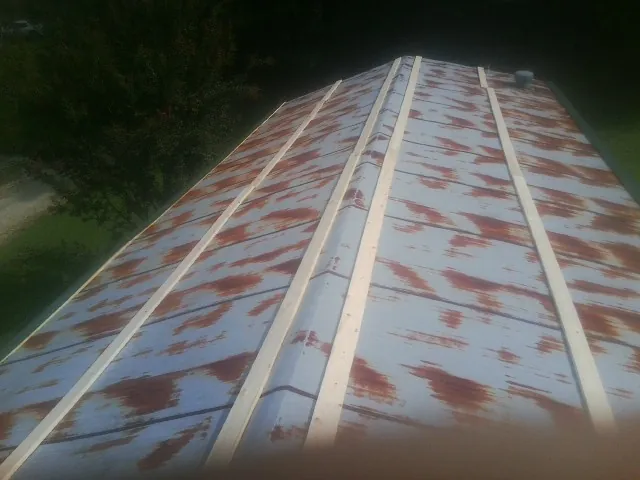Rusted metal roof panels with new wood purlins before replacement — Storm Damage Roof Repair in Clifton Springs by Roofing Brothers
